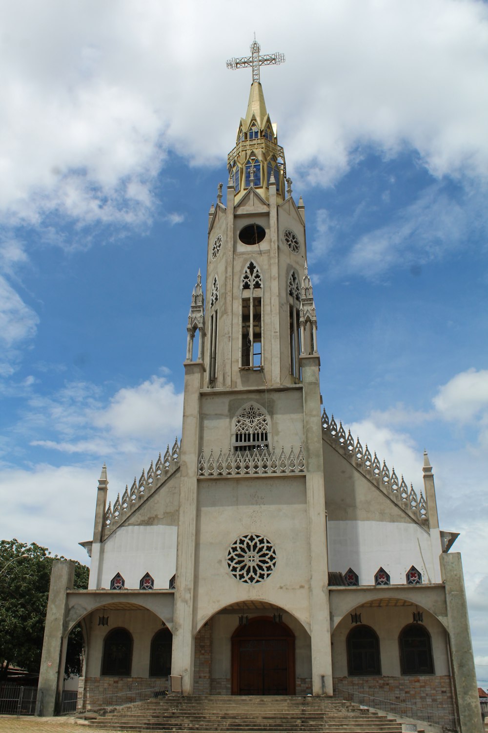 a church with a steeple and a cross on top