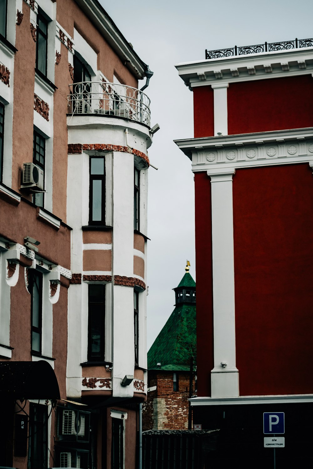 a tall red and white building next to a tall red and white building