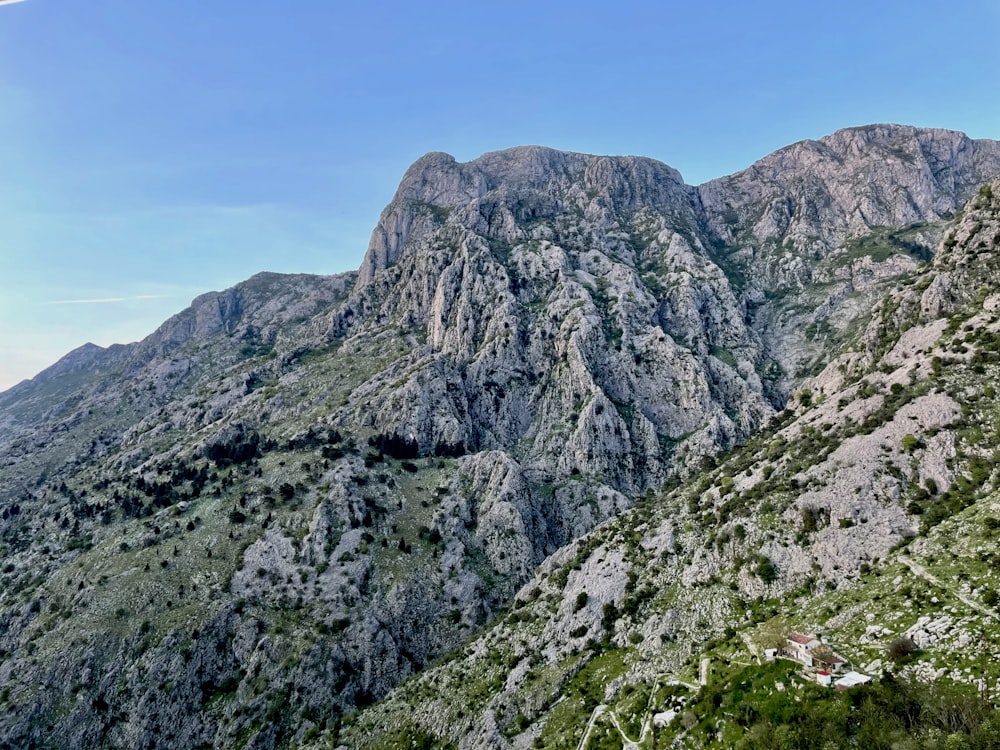 a view of a mountain range from the top of a hill