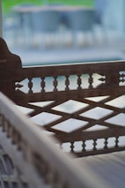 Close-up of handcrafted wooden garden bench with intricate detailing.