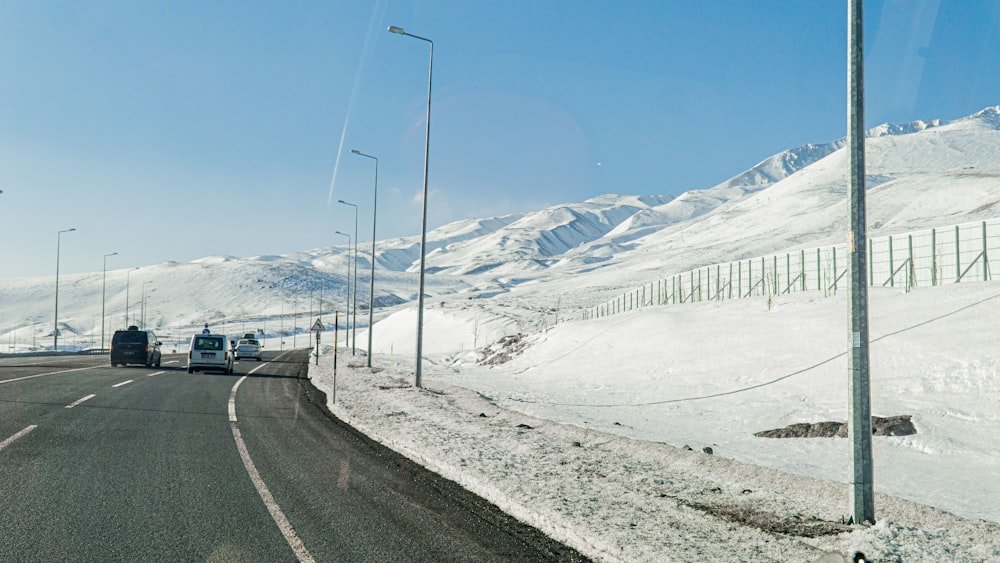 a large truck driving down a snow covered road