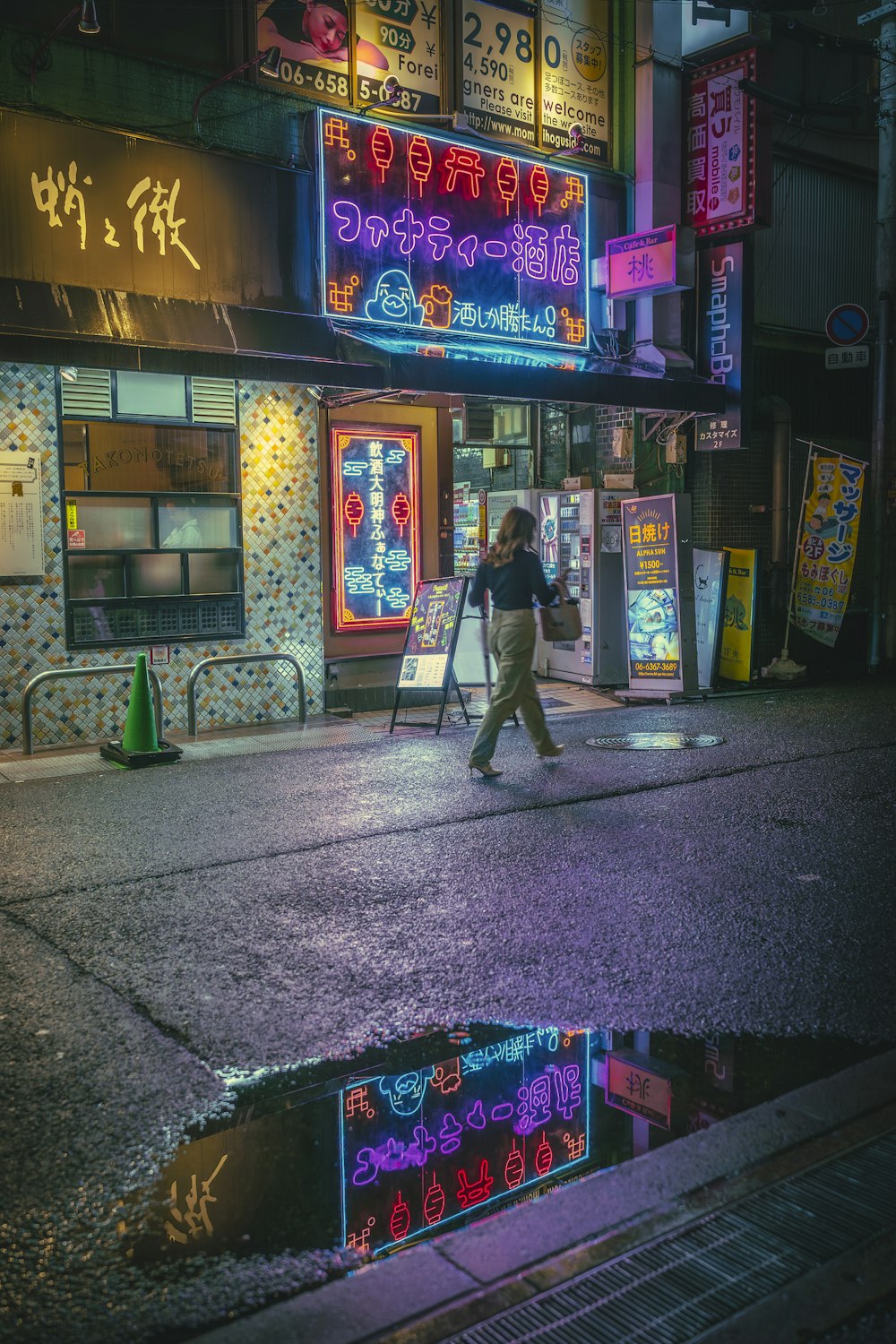 a person walking down a street at night