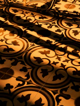 Warm entryway showcasing a beautifully laid tile floor with intricate patterns and natural light.