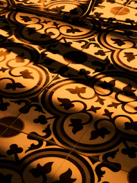 Close-up of a beautifully installed warm-toned floor tile pattern in a cozy living room.