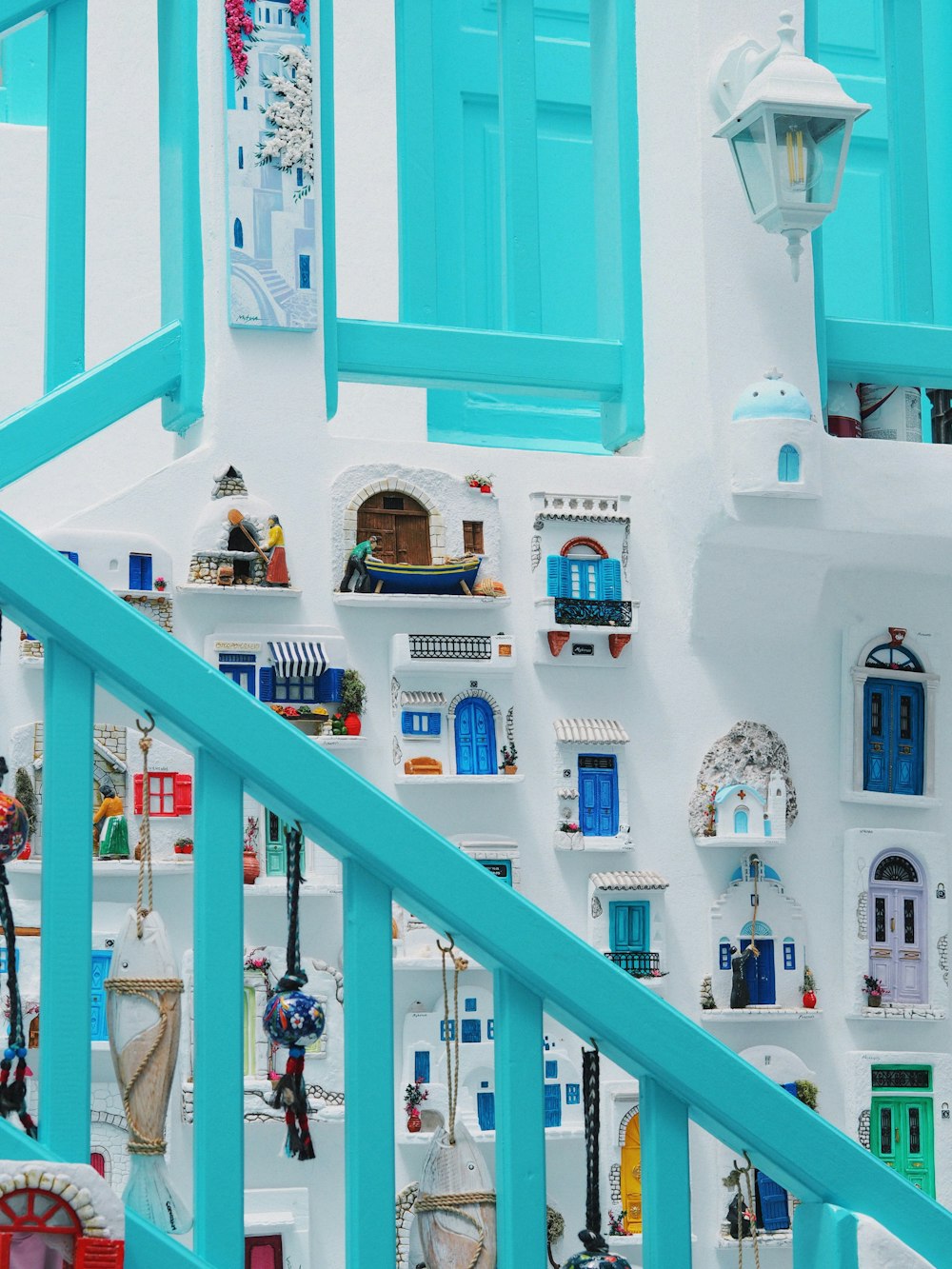 a staircase leading up to a white building with blue shutters