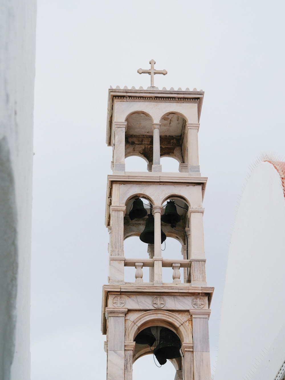 a tall tower with a cross on top of it