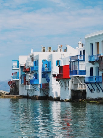 a row of buildings with blue balconies and red and white balconies