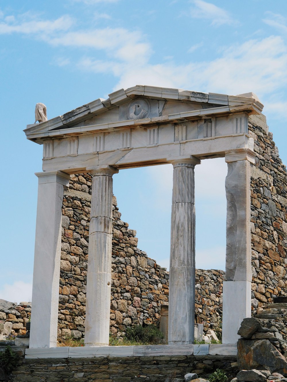 a stone structure with a clock on top of it