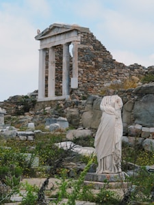 a statue of a woman standing in front of a building