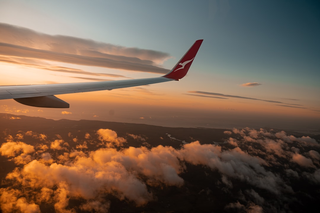 a view of the wing of a plane in the sky