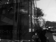 An abstract reflection of faces in a rain-soaked window, symbolizing the complexity of human behavior.