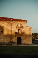 an old brick building with a clock on it