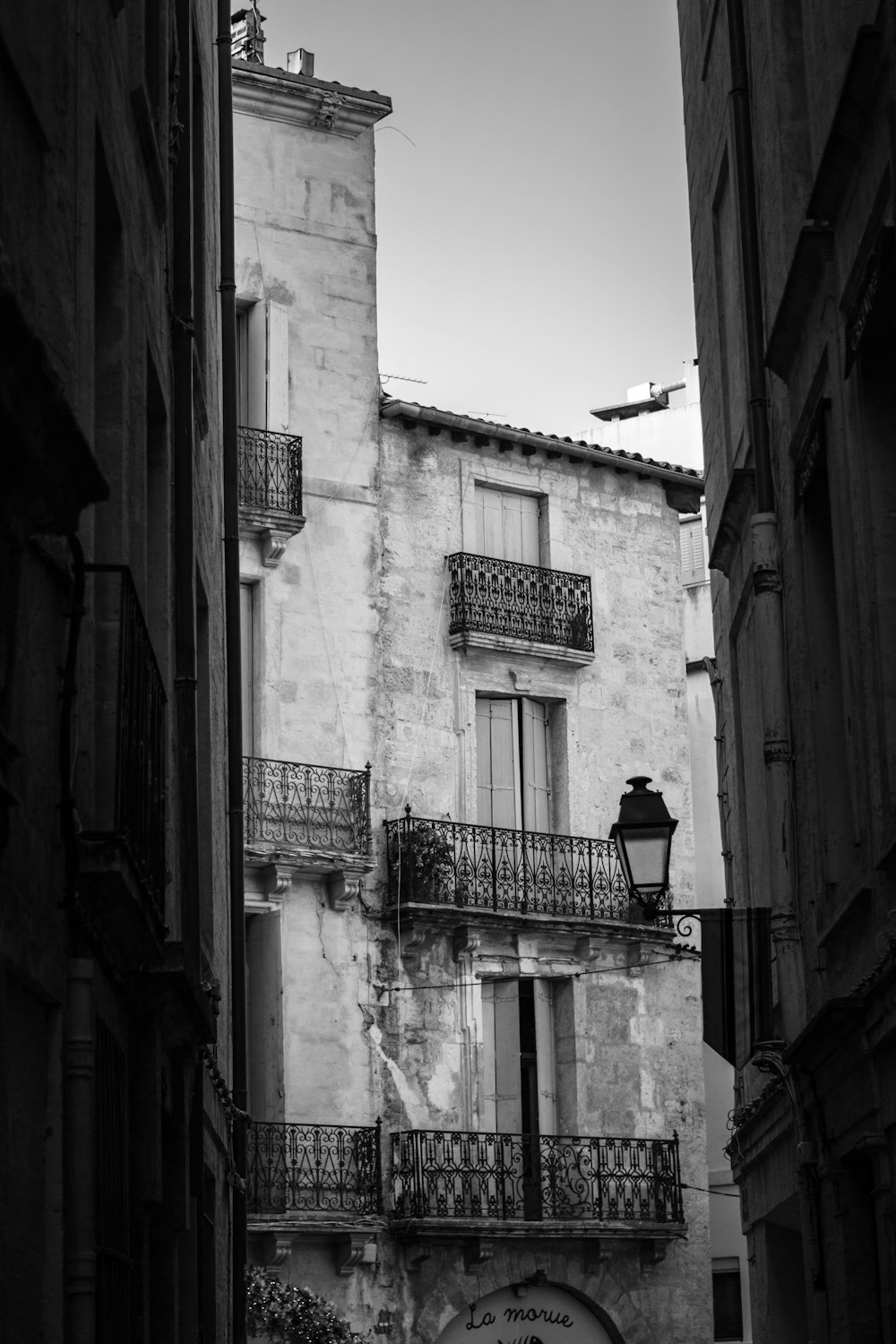 a black and white photo of a building with balconies