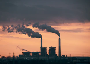 a factory with smoke coming out of it's stacks