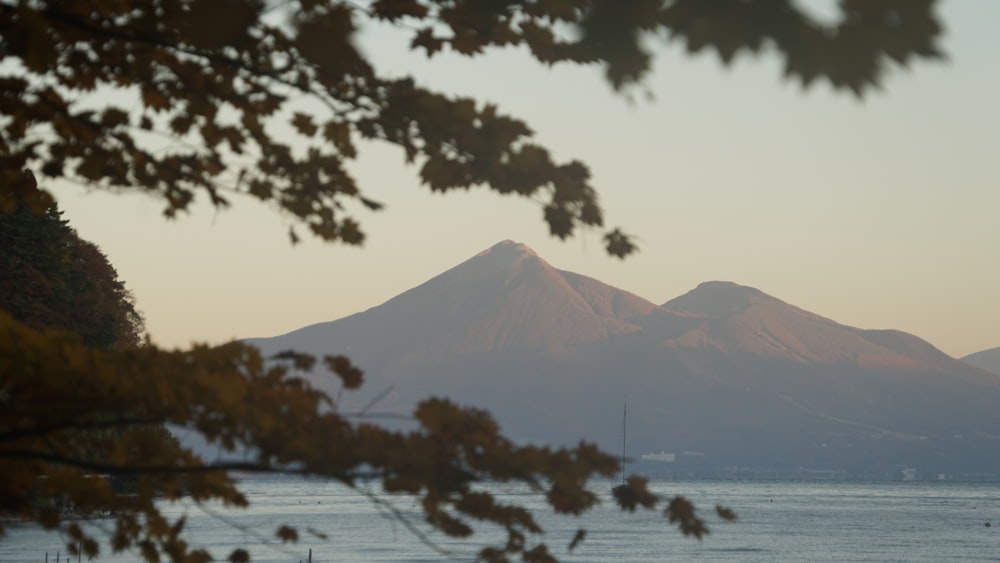 a view of a mountain with a body of water in the foreground