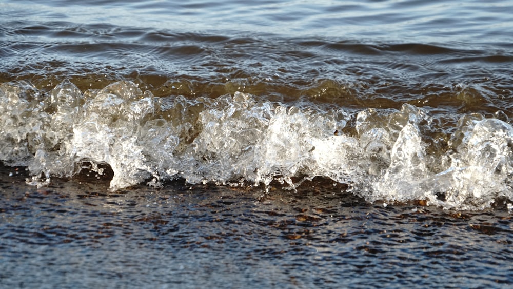 a close up of a wave on the beach