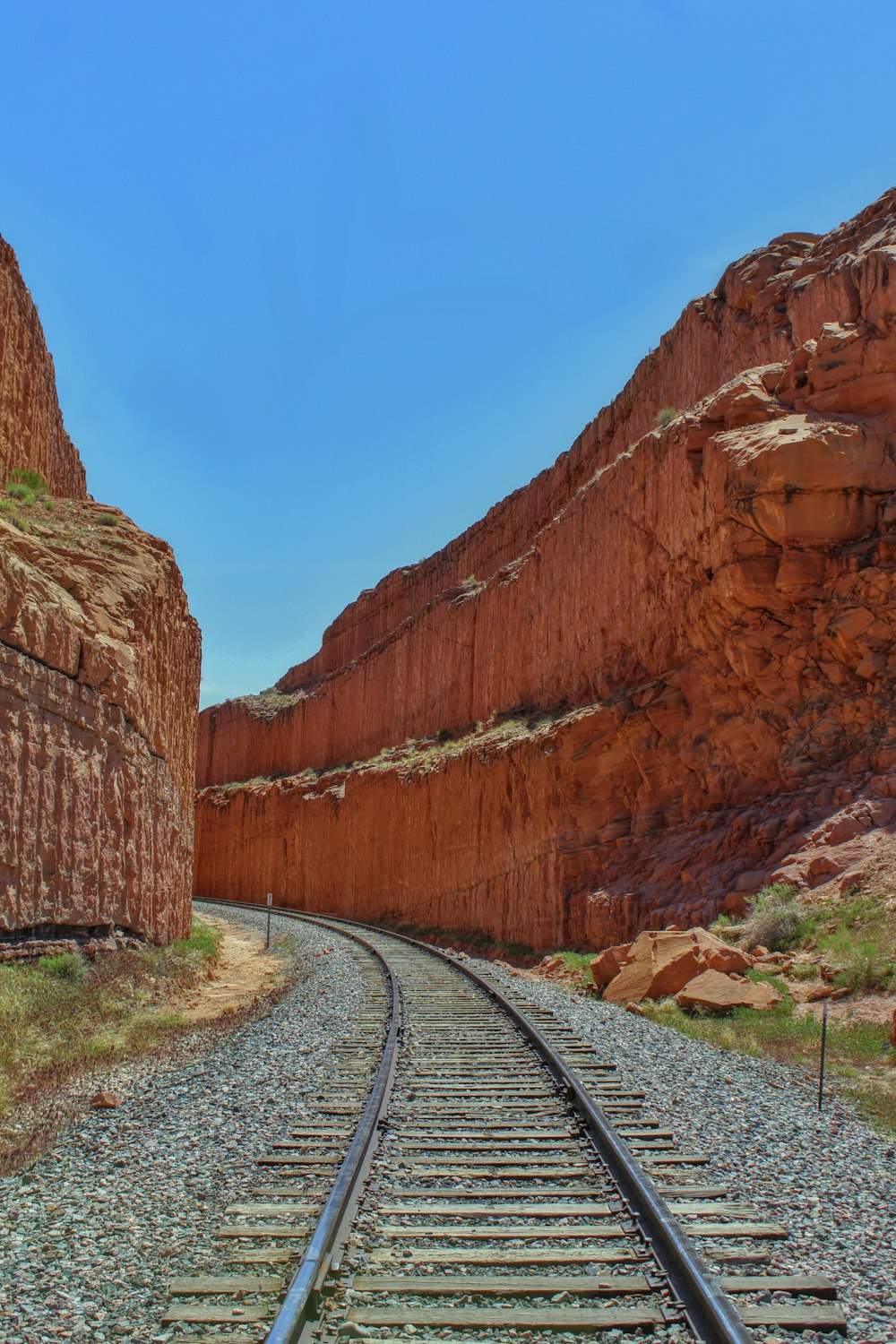 a train track in the middle of a canyon