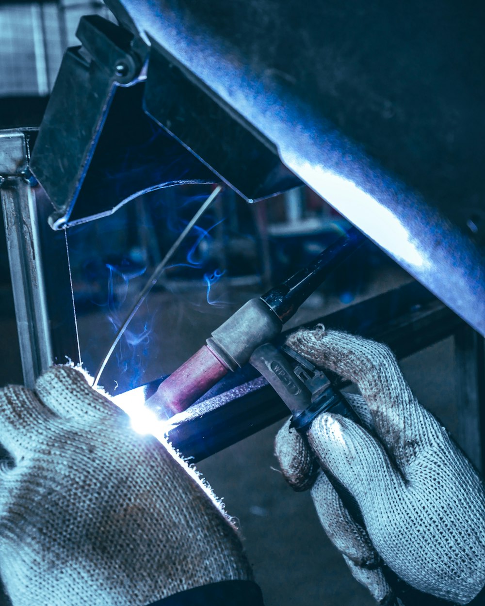 welder working on a piece of metal in a factory