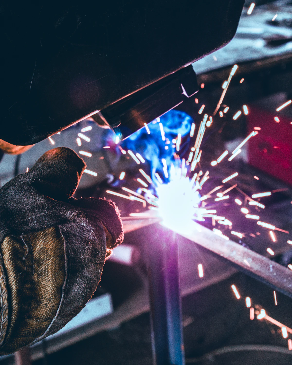 Welder working on metal in an industrial workshop