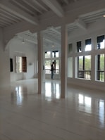 Spacious bedroom with natural light streaming through large windows in a resale apartment.