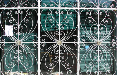 Intricate steel grills designed for security and aesthetic appeal on a home window.