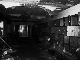 An empty evidence locker with a broken lock and scattered papers on the floor.