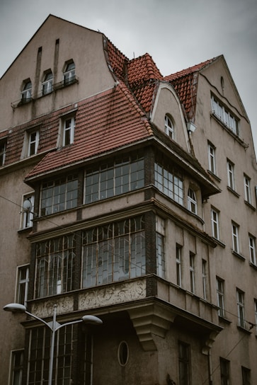 an old building with a red tiled roof