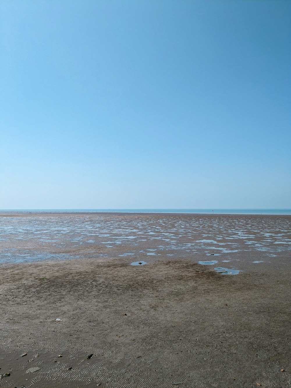 a view of a large body of water from a beach