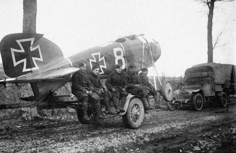 a group of men sitting on top of an airplane