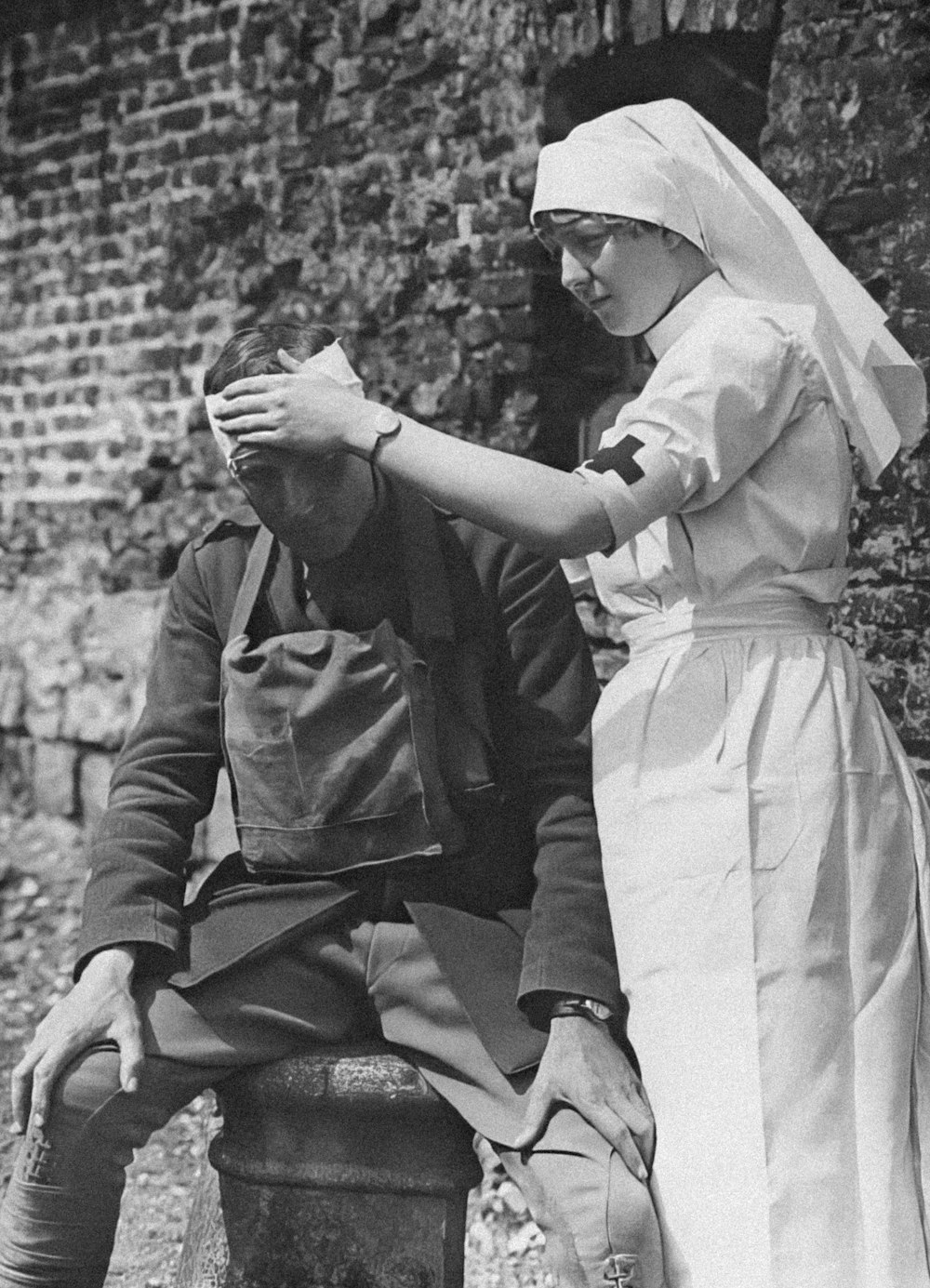 an old photo of a woman combing a man's hair