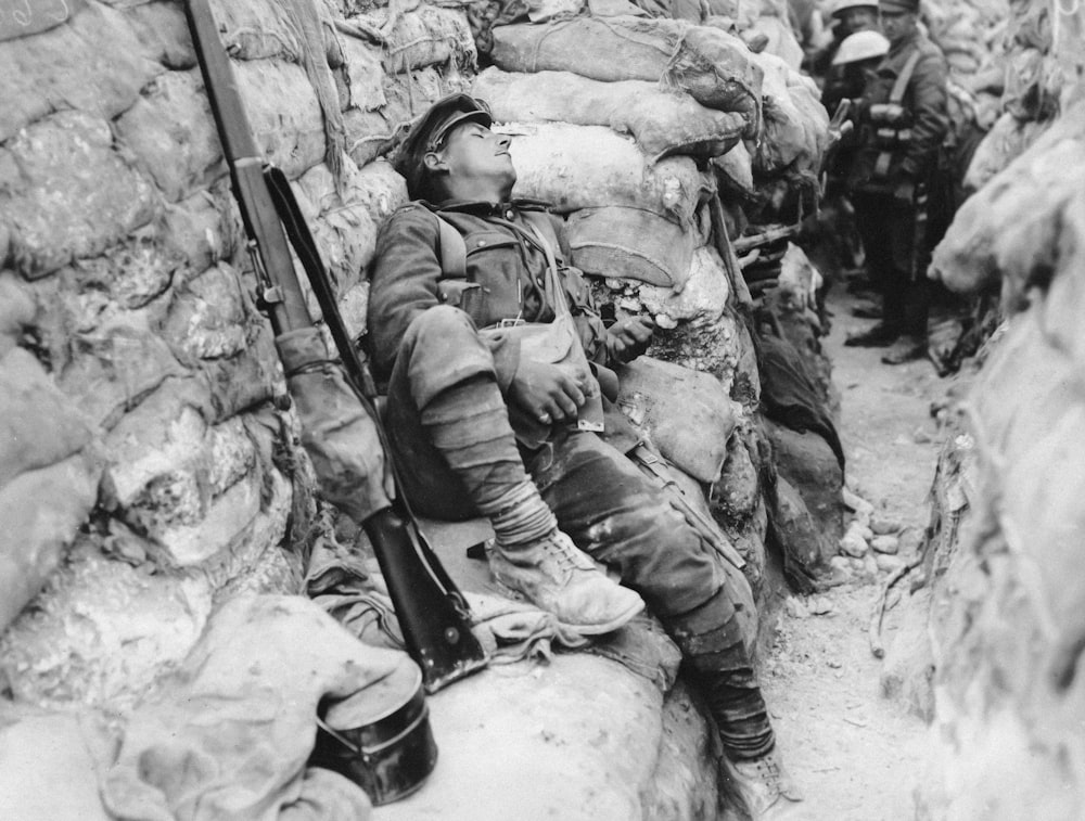 a black and white photo of a man with a gun