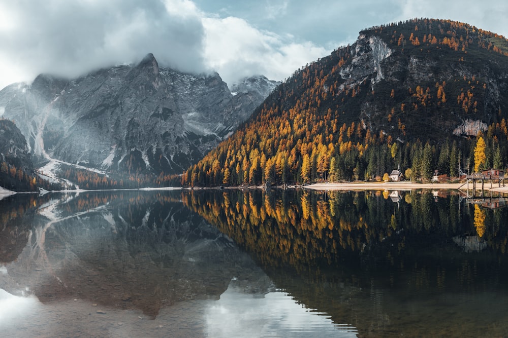 a mountain range with a lake surrounded by trees