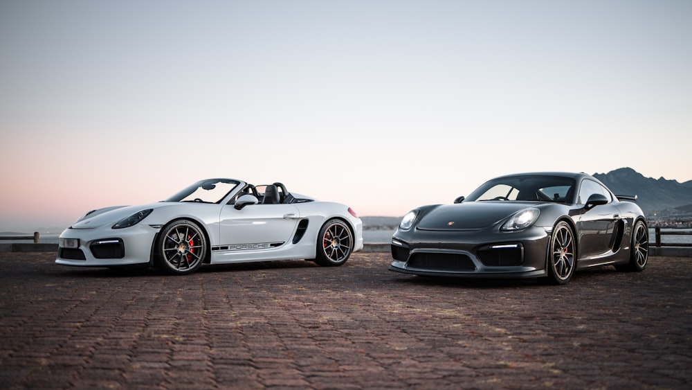 two porsche sports cars parked next to each other