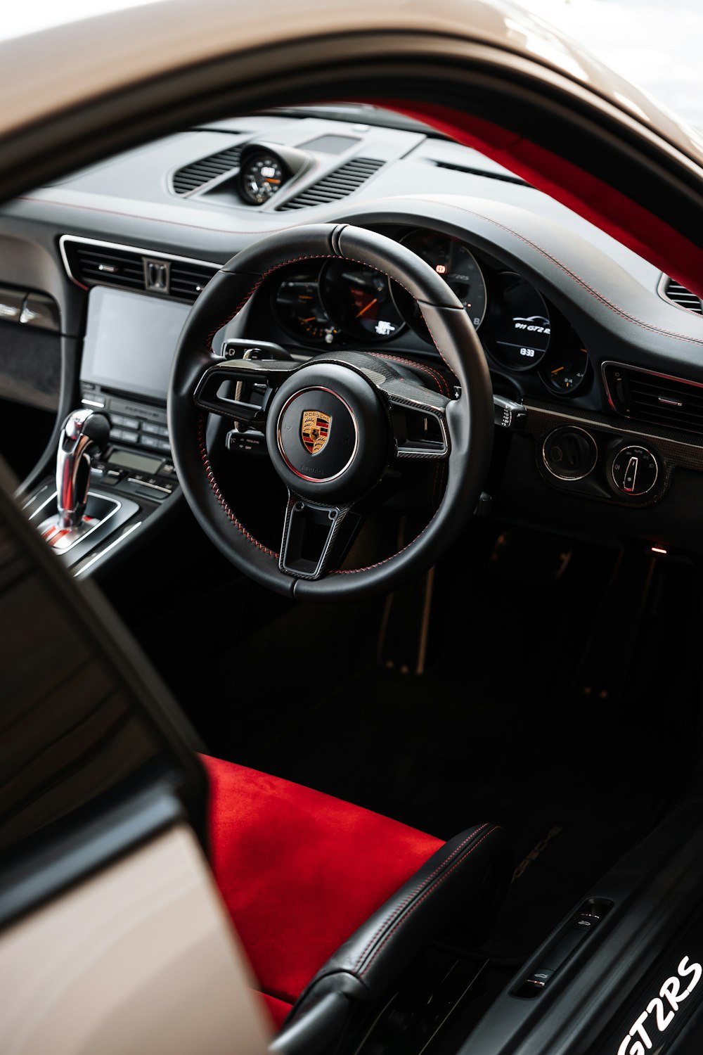 the interior of a sports car with a red carpet
