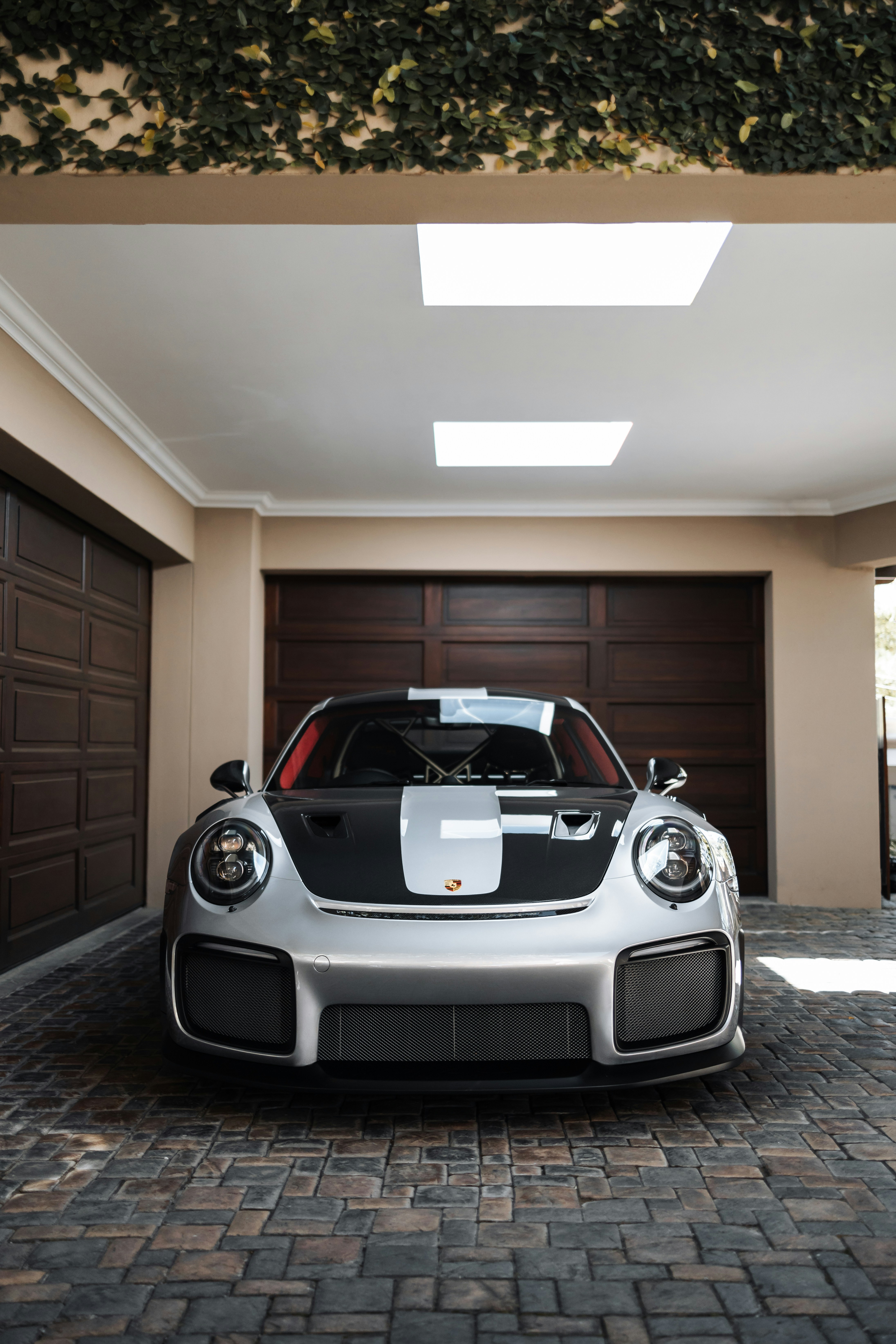 a white and black sports car parked in a garage