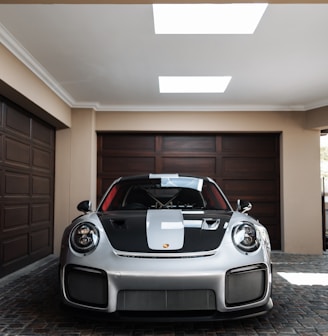 a white and black sports car parked in a garage