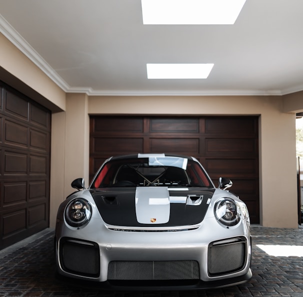 a white and black sports car parked in a garage