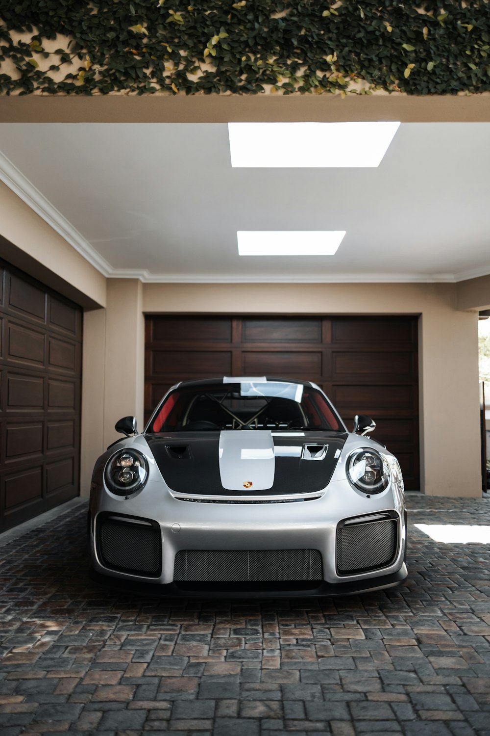 a white and black sports car parked in a garage