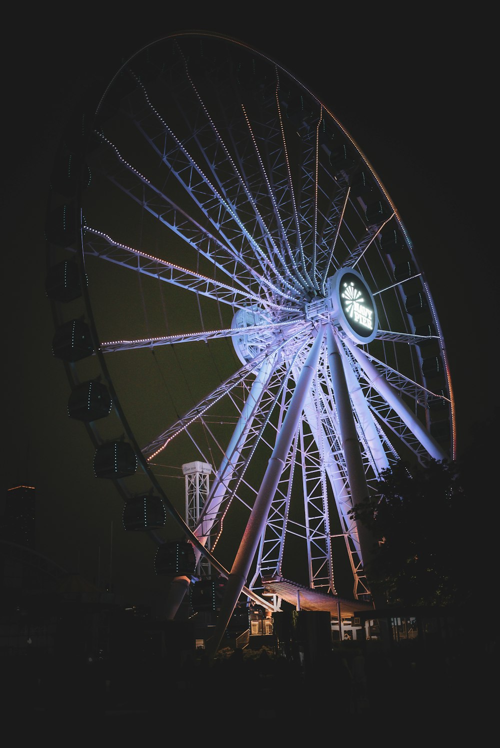 a large ferris wheel lit up at night