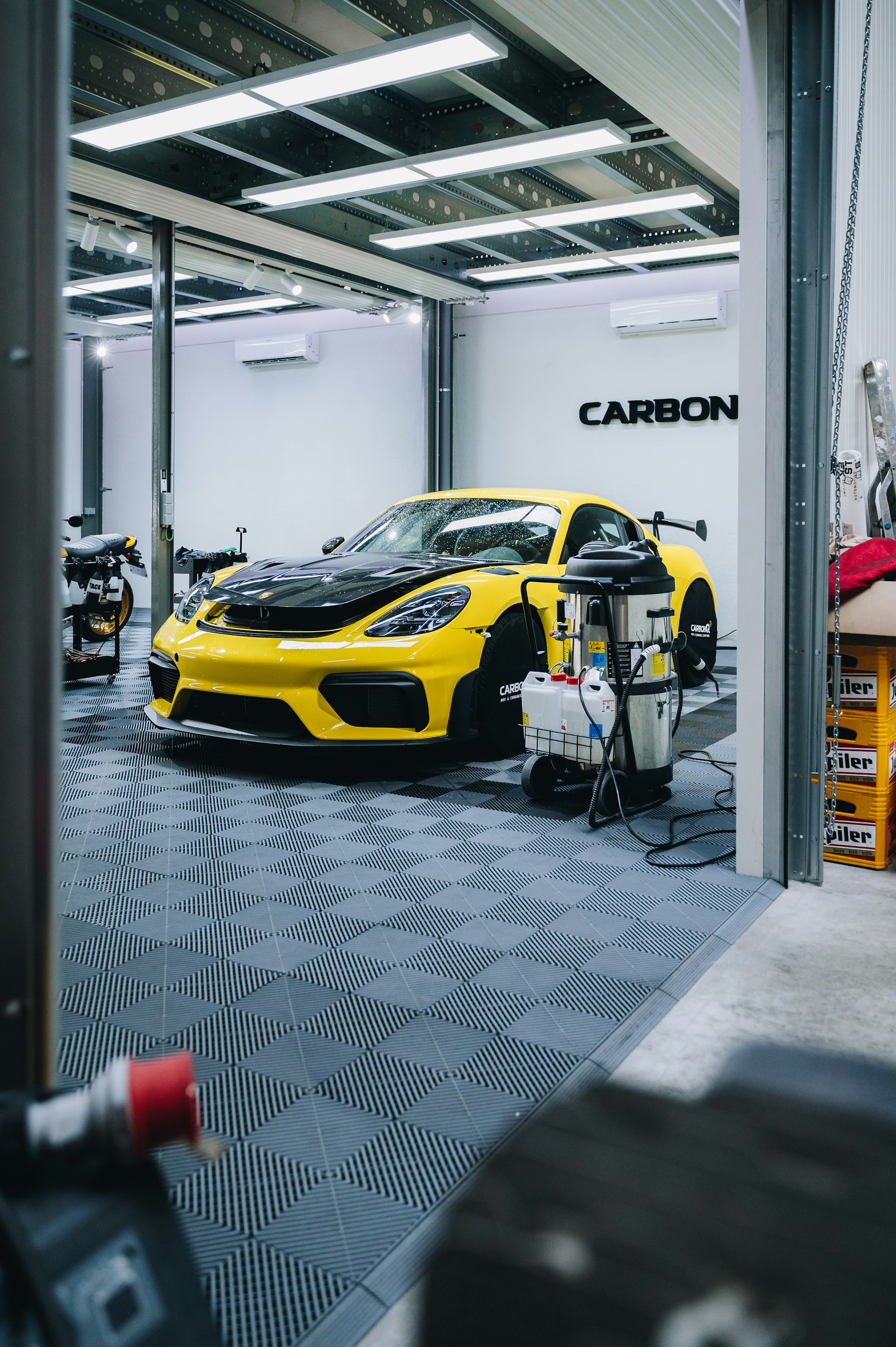 a yellow sports car is parked in a garage