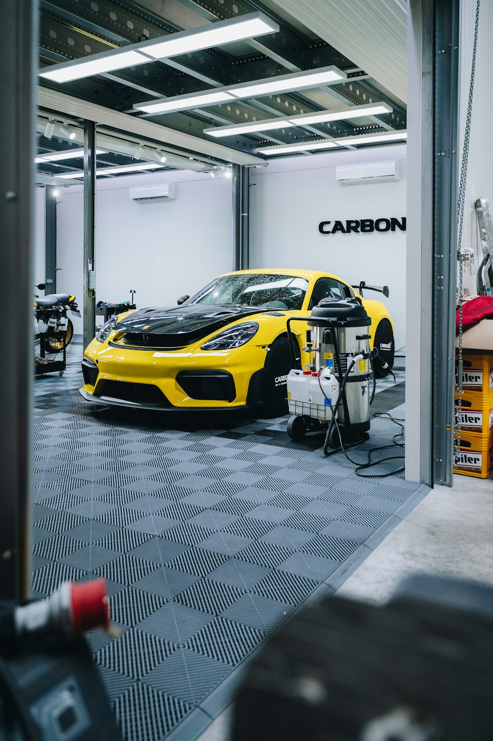 a yellow sports car is parked in a garage