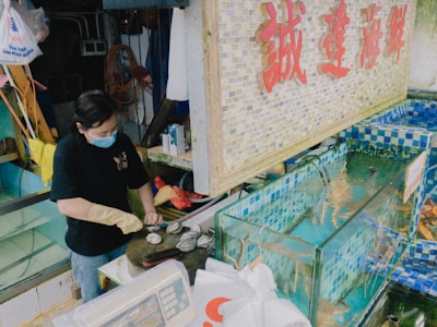 Workers carefully packaging seafood in a clean processing facility.
