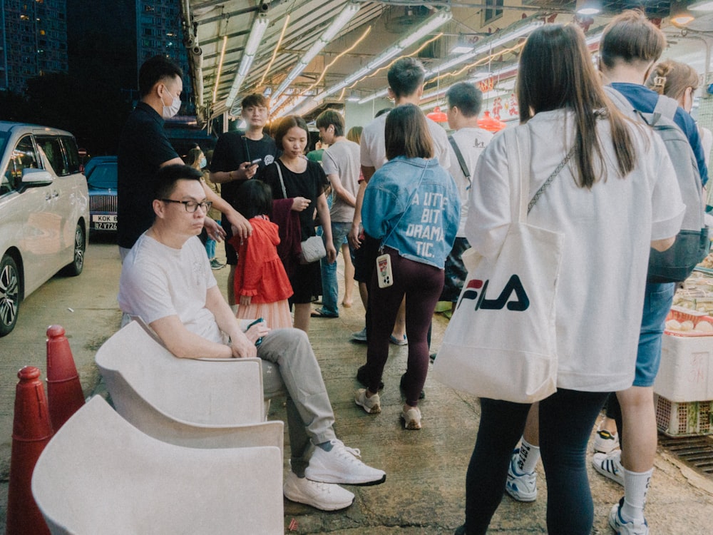 a group of people standing around a market