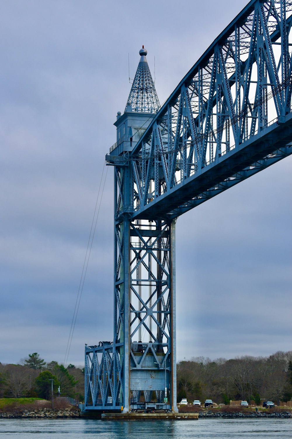 a large blue bridge spanning over a body of water
