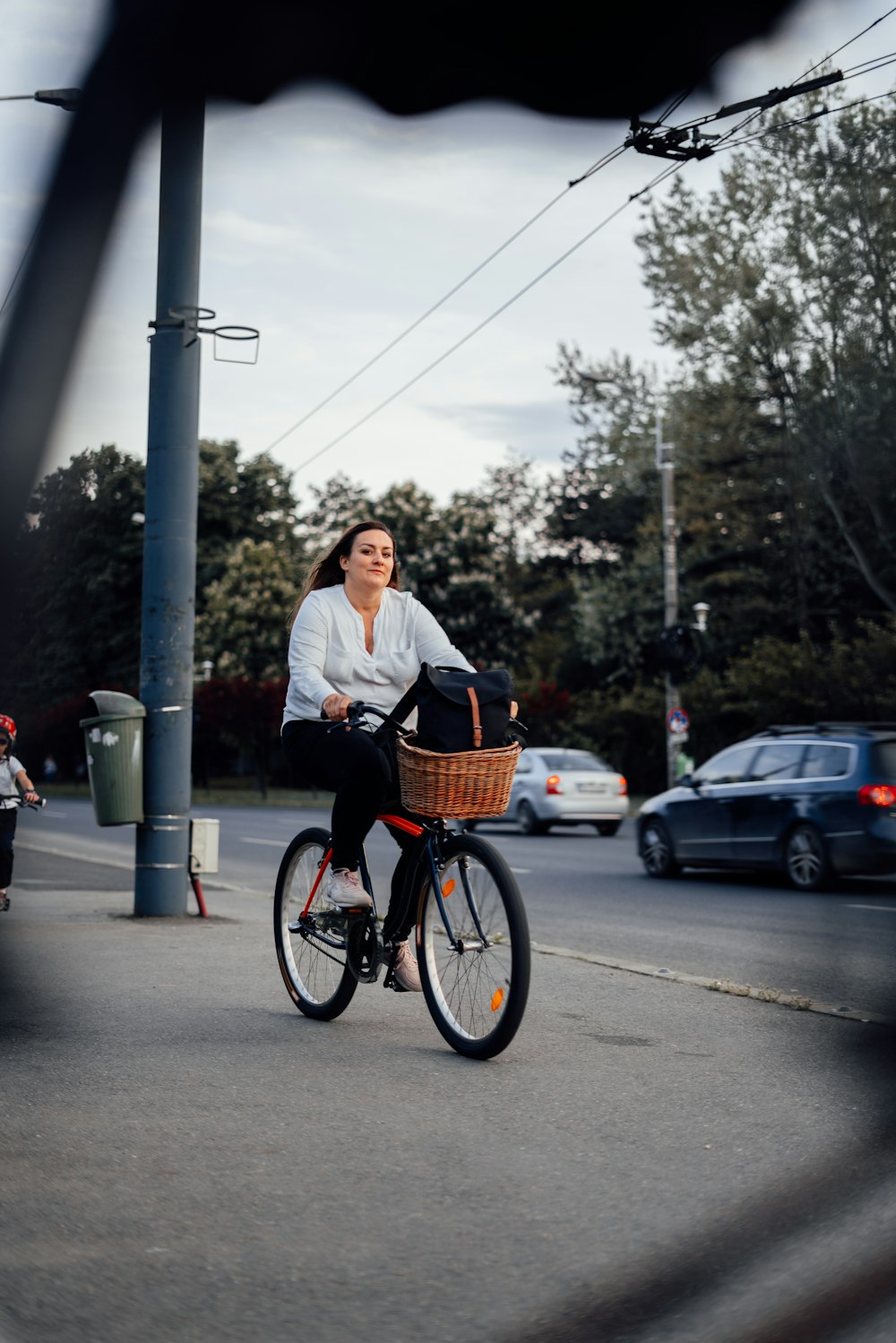 a woman riding a bike down a street