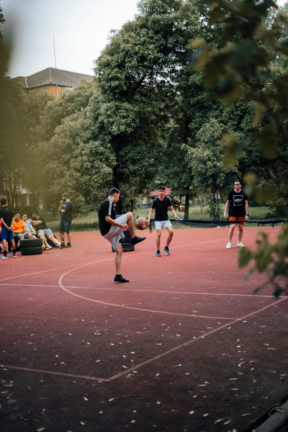 a group of young men playing a game of basketball