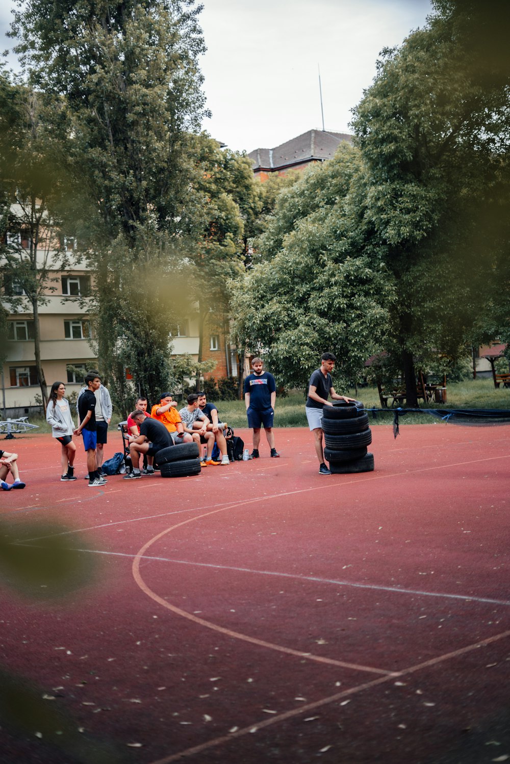 a group of people standing around a basketball court
