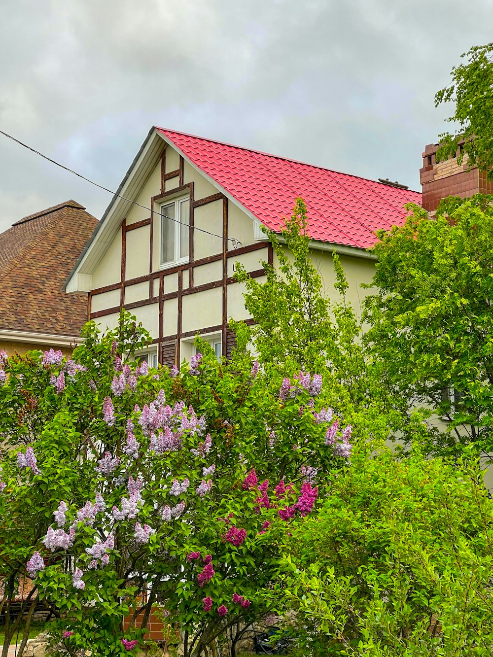 a house with a red roof surrounded by trees