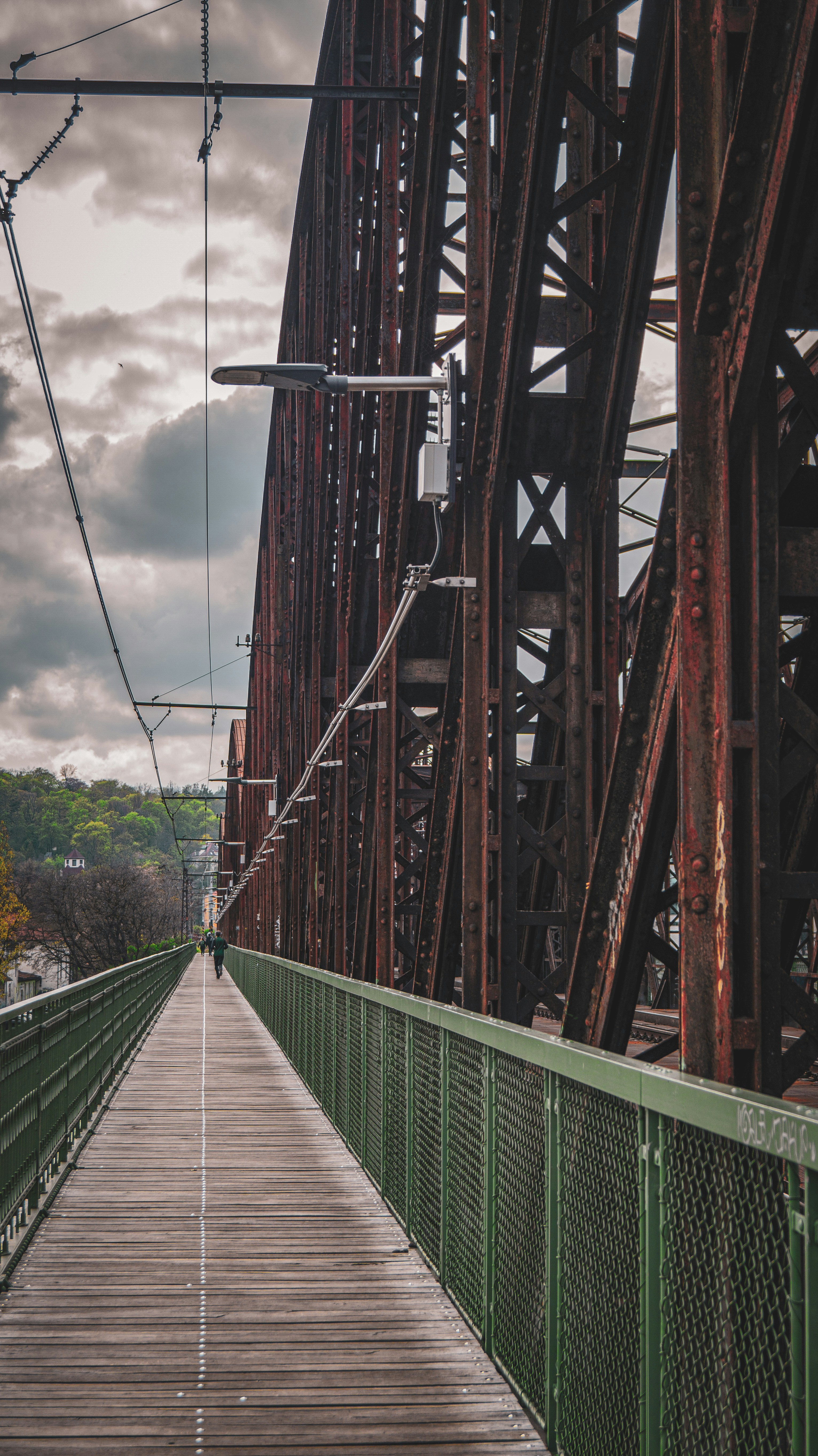 a long bridge with a person walking across it