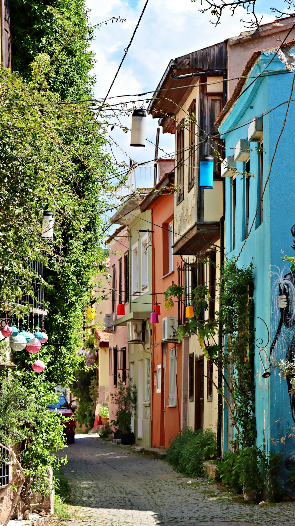 a cobblestone street lined with colorful buildings